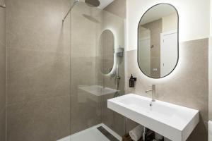 a bathroom with a sink and a mirror at Ola Living Chamartín Studios in Madrid