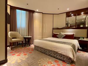 Voodi või voodid majutusasutuse Macau Masters Hotel toas