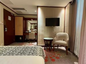 Televiisor ja/või meelelahutuskeskus majutusasutuses Macau Masters Hotel