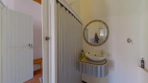 a bathroom with a sink and a mirror on the wall at Tradouw Guesthouse in Barrydale +59 photos