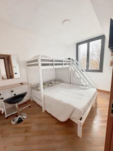 a bedroom with a white bunk bed and a desk at Bed & Bergamo Casa Vacanze in Bergamo +10 photos