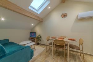 a living room with a table and a couch at Pasteur Collection - Cozy & Warm - 4pers in Villeurbanne