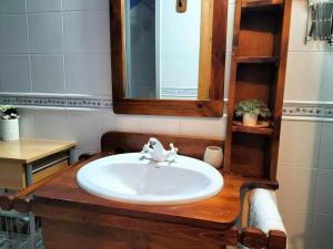 a bathroom with a sink and a mirror at El Cajigar Ordesa Aínsa in Laspuña +43 photos