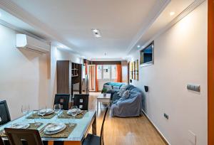 a living room with a table and a couch at Nice sea view in Roquetas de Mar