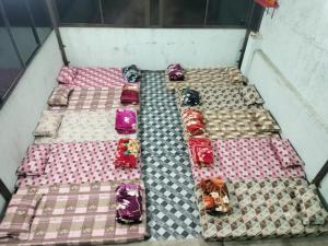 a group of four beds in a room at jyoti dormitory in Varanasi