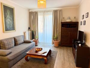 a living room with a couch and a coffee table at HappyStayApartments in Villach