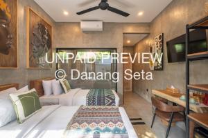 a hotel room with two beds and a table at Lila Nest in Ubud