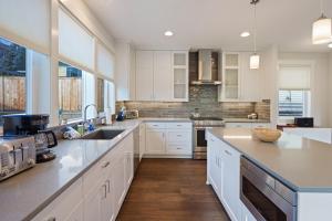 a kitchen with white cabinets and a counter top at Hillside Haven in Bend