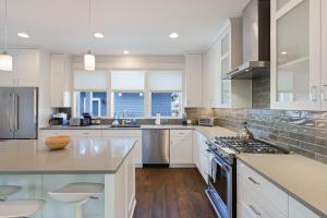 a kitchen with white cabinets and a counter top at Hillside Haven in Bend +31 photos
