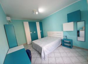 a bedroom with a bed and a blue wall at Casa Piero in Lecce