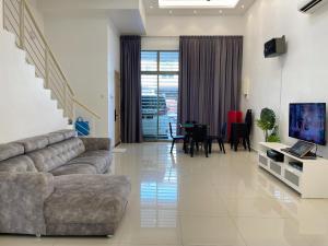 a living room with a couch and a dining room at Kuala Selangor 93 in Kuala Selangor