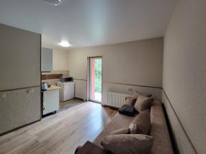a living room with a couch and a kitchen at Glory Apart Hotel in Truskavets