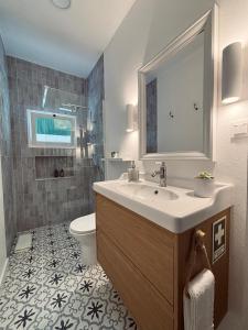 a bathroom with a sink and a toilet at Casa D'Avó Bá in Évora +13 photos