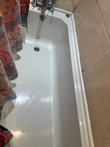 a shower in a bathroom with a white tub at A beautiful tranquil home in Birmingham