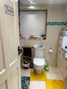 a bathroom with a toilet in a small room at A beautiful tranquil home in Birmingham