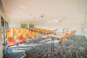 an empty lecture room with desks and chairs at Centre Jean XXIII in Annecy