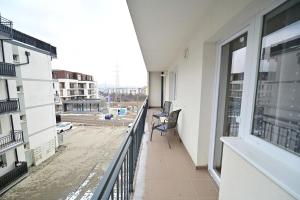 a balcony of a building with a chair on it at Alina Sweet Home in Sibiu