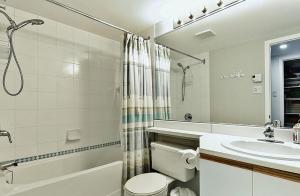 a bathroom with a toilet and a sink and a shower at Hameau 28-51 Studio in Stoneham +8 photos