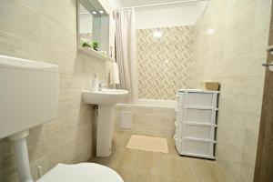 a bathroom with a toilet and a sink at Alina Sweet Home in Sibiu +35 photos
