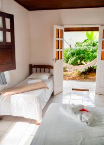 Letto o letti in una camera di Pousada Coco Dendê