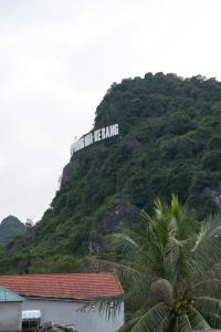 a sign on the side of a hill with trees at Phong Nha Magic Fingers Homestay and Spa in Phong Nha