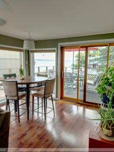 a dining room with a table and chairs at Forever Red Cottage, Waterfront home on Cayuga Lake near FLX wineries in Seneca Falls
