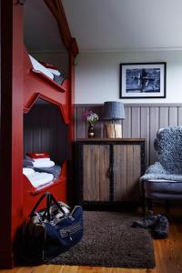 a room with two bunk beds and a chair at Buustamons Fjällgård in Åre