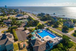 an aerial view of a resort with a swimming pool and the ocean at The Shabedge at Ships Watch in Duck