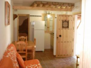 a kitchen with a white refrigerator and a table at Finca El Abuelo in Barbate