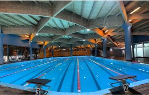 a large swimming pool with blue water at Beachfront Apartments Durres in Durrës