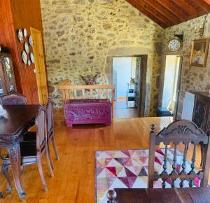 a living room with a stone wall at Vila Margarida in Porreiras