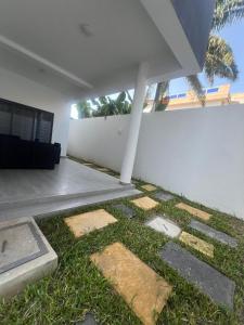 a patio with grass and stepping stones in a house at Appartement meublé a la RDC in Cotonou Cadjehoun