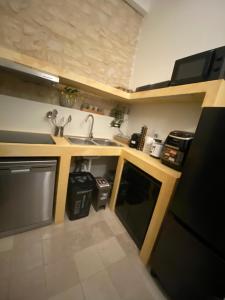 a small kitchen with a sink and a dishwasher at Easter Suite in Acquaviva delle Fonti +17 photos