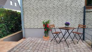 a table and chairs with flowers on a patio at Ruhezone in Dieburg