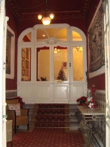 a living room with a large window and stairs at Hotel Villa de Luarca in Luarca