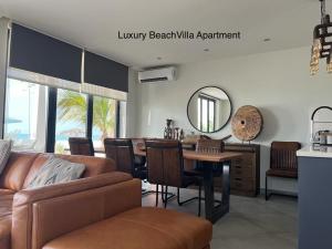 a living room with a couch and a table with a mirror at Luxury Beach Villa, Praia de Chaves, Boa Vista in Boa Ventura