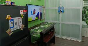 a childs room with a television and a refrigerator at Uncle's Tagaytay Staycation in Iruhin