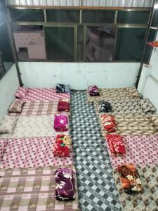 a group of beds in a room with at jyoti dormitory in Varanasi