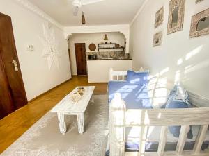 a bedroom with a bed and a table in it at Own Compound Nested One Bedroom Villa in Mtwapa