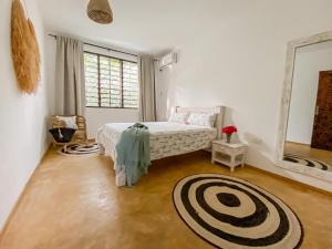 a bedroom with a bed and a large window at Own Compound Nested One Bedroom Villa in Mtwapa