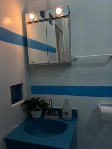 a bathroom with a blue sink and a mirror at Casa Rústica los Arcos in Atlixco +6 photos