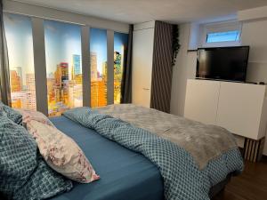 a bedroom with a bed with a flat screen tv at Schöne Souterrain Wohnung in Herzogenrath mit Sauna! in Herzogenrath