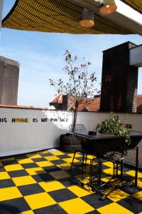 a yellow and black checkered floor with a table and a tree at Hotel The Exchange in Amsterdam
