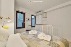 a bedroom with a bed with towels on it at Yellow Submarine, Terre Marine in Manarola