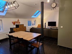 a dining room with a table and a bedroom at Peace&Loft in Durbuy Old in Durbuy