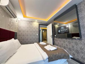 A bed or beds in a room at Akayda Butik Hotel