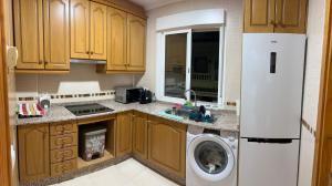 a small kitchen with a washing machine in the kitchen at Mi Huésped Zújar, Baza in Zújar