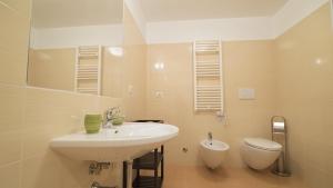 a bathroom with a sink and a toilet at Le Lune di Diana in Matera +16 photos