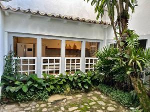 a white house with a white fence at Casa Odara Paraty in Paraty