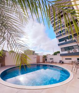 a large swimming pool in front of a building at Hotel Saint Paul in Manaus